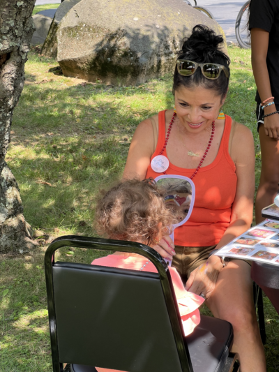 Councilwoman painting a childs face