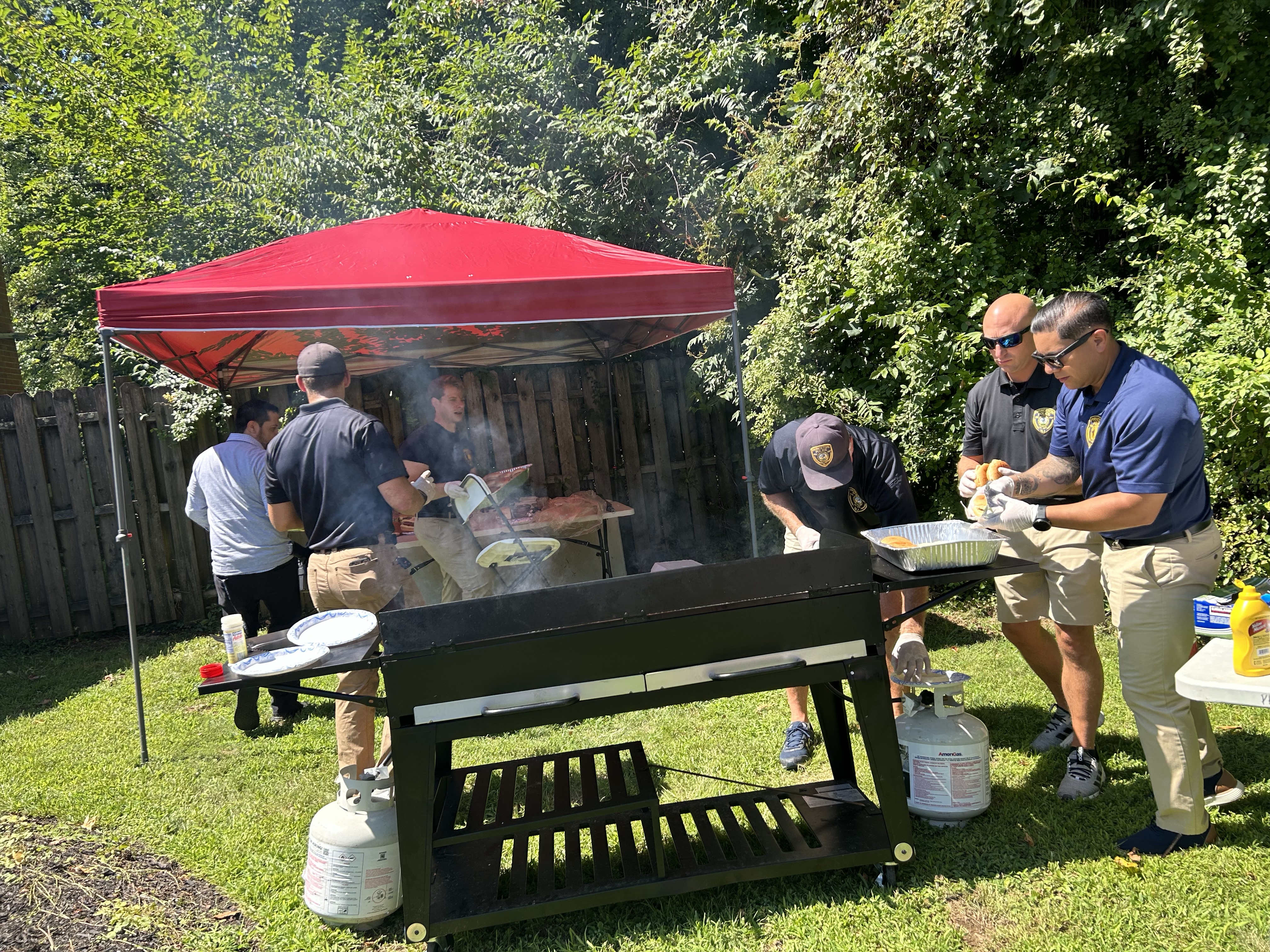 Group photo of members cooking on a grill